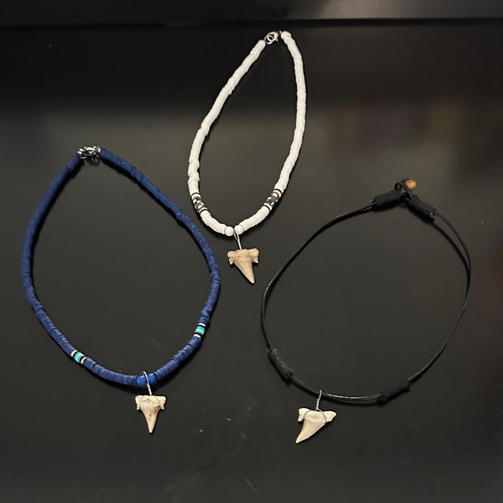Three shark tooth necklaces